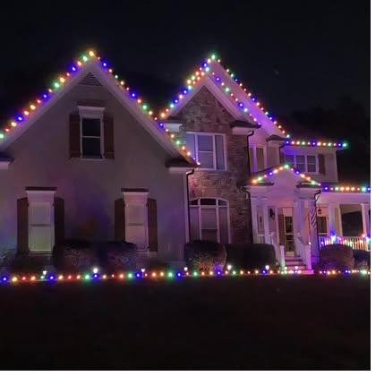 Traditional multicolor holiday lighting option on a home roofline