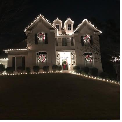 Georgian-style windows with matched wreaths and roofline lighting